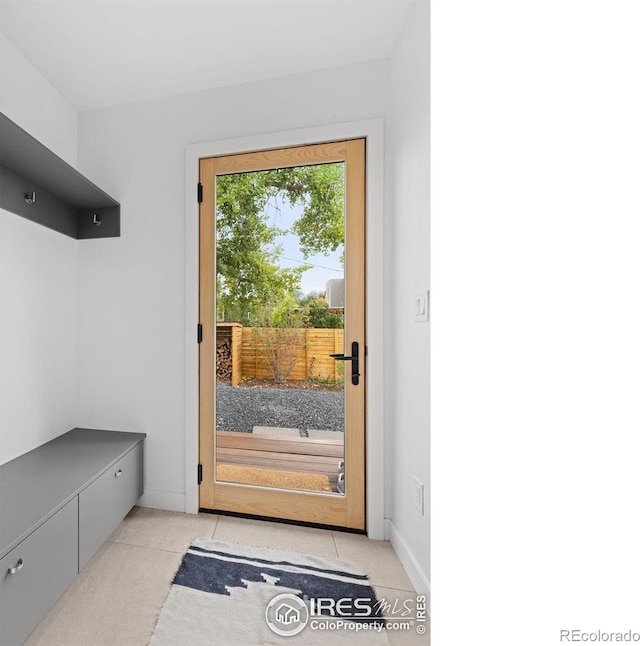 mudroom featuring light tile patterned floors and baseboards