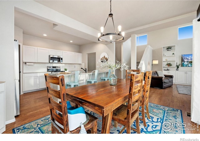 dining space with dark hardwood / wood-style flooring and a notable chandelier