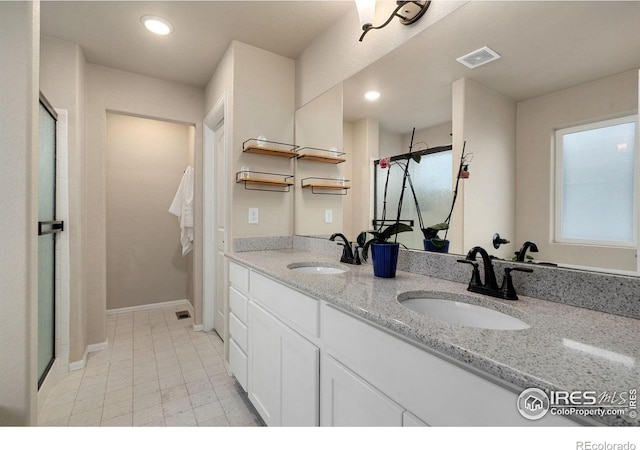 bathroom with walk in shower and vanity