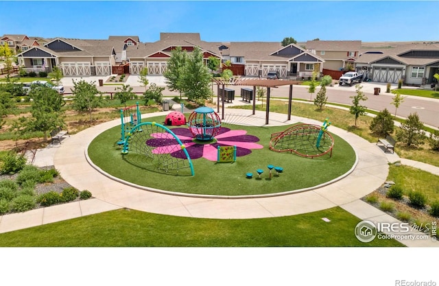 view of property's community featuring a playground, a pergola, and a lawn