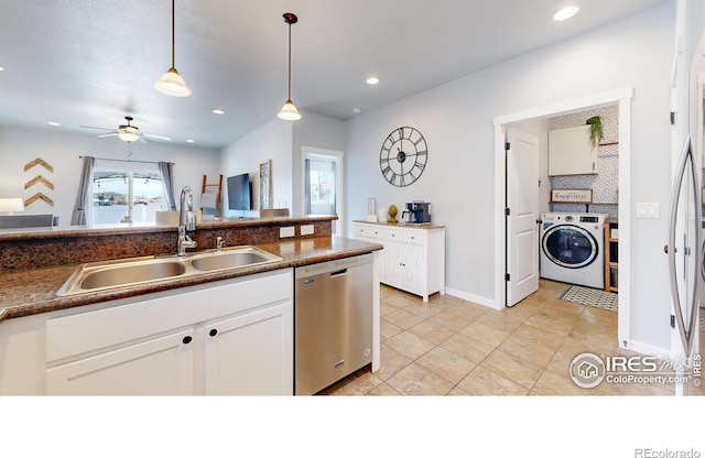 kitchen featuring sink, dishwasher, hanging light fixtures, white cabinets, and washer / clothes dryer