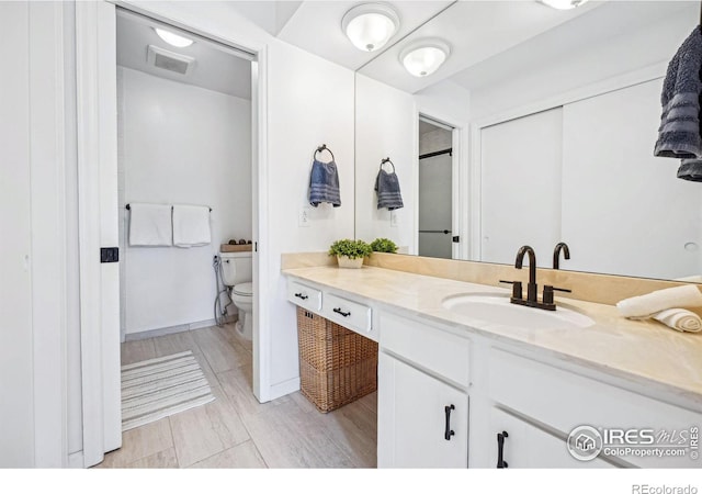 bathroom with vanity and toilet