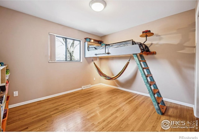 unfurnished bedroom with wood-type flooring