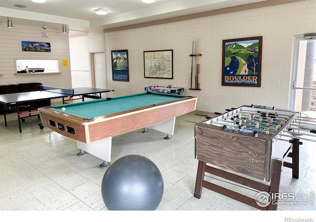 rec room featuring brick wall and billiards