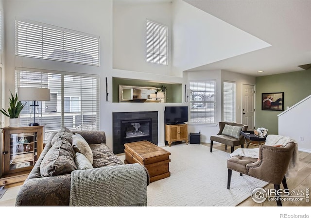 living room with a towering ceiling and light hardwood / wood-style floors