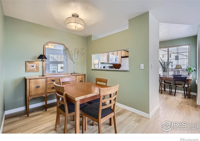 dining space featuring light wood-type flooring