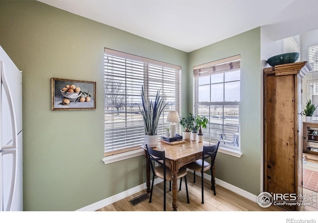 dining space with light hardwood / wood-style flooring