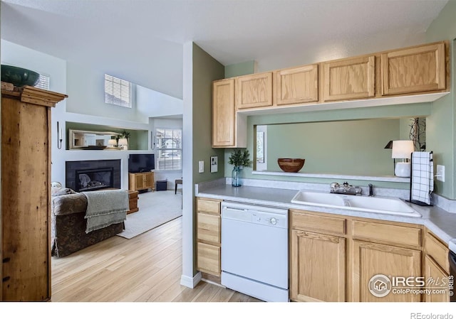 kitchen with white dishwasher, light brown cabinetry, sink, and light hardwood / wood-style flooring