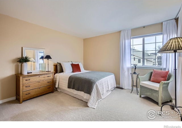 bedroom featuring light colored carpet