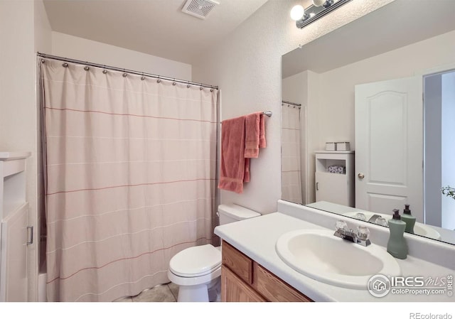 bathroom with vanity, walk in shower, and toilet