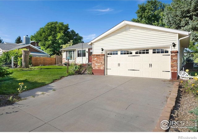 view of front of property featuring a garage and a front lawn