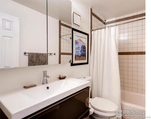 bathroom with toilet, vanity, and shower / bath combination with curtain