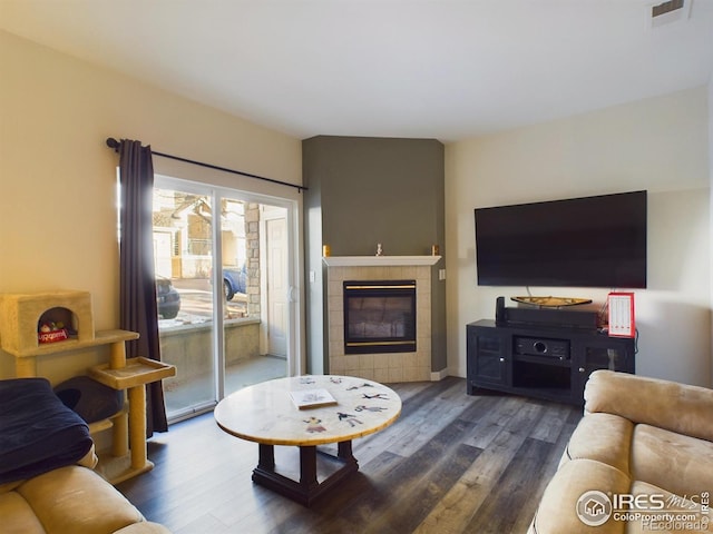 living room featuring a fireplace and dark hardwood / wood-style floors