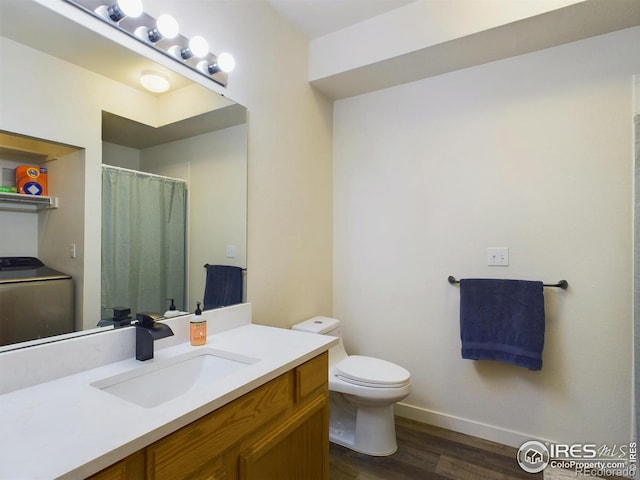 bathroom featuring vanity, washer / dryer, toilet, and hardwood / wood-style flooring