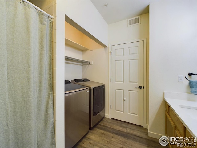 laundry room featuring separate washer and dryer and dark hardwood / wood-style flooring