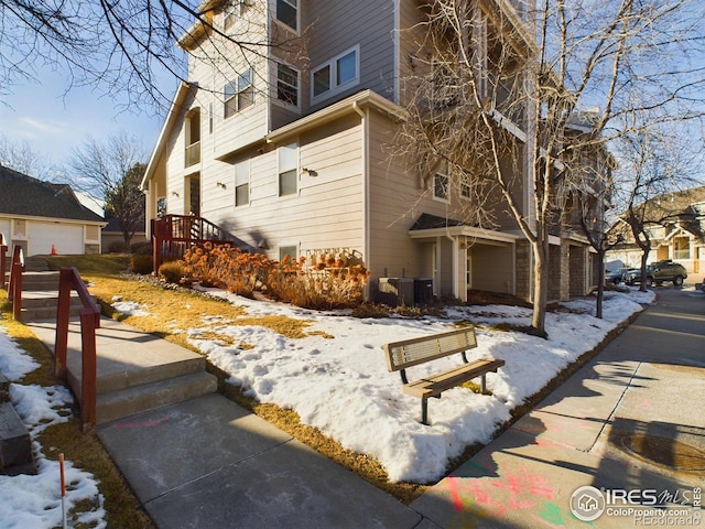 exterior space featuring cooling unit and a garage