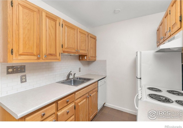 kitchen with sink, backsplash, white appliances, and dark tile patterned flooring