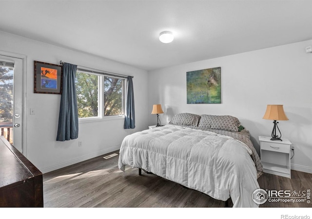 bedroom with hardwood / wood-style flooring