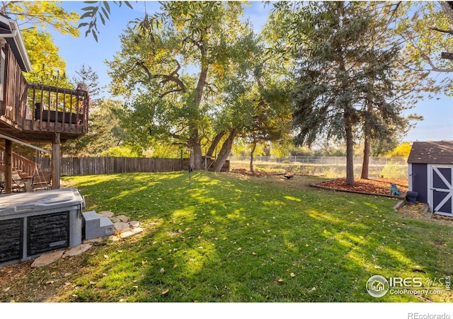 view of yard featuring a shed and a hot tub