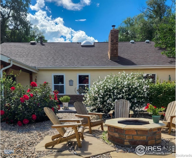 rear view of house featuring an outdoor fire pit and a patio