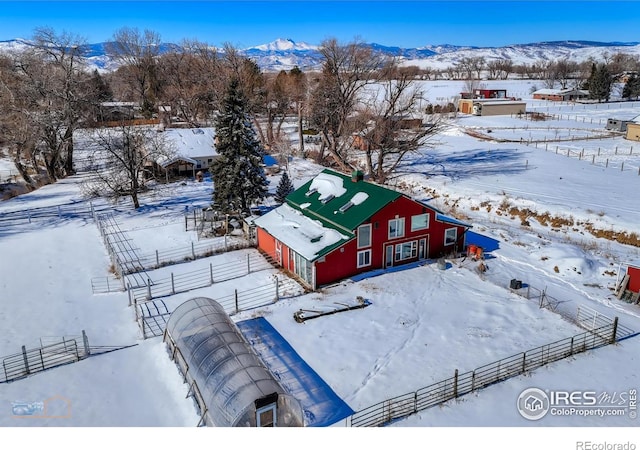 snowy aerial view with a mountain view