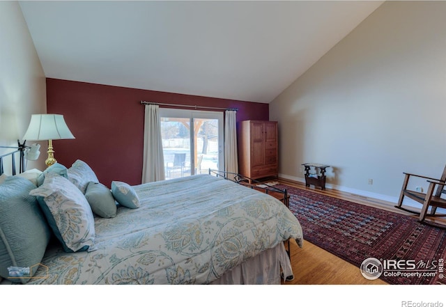 bedroom with hardwood / wood-style flooring and vaulted ceiling