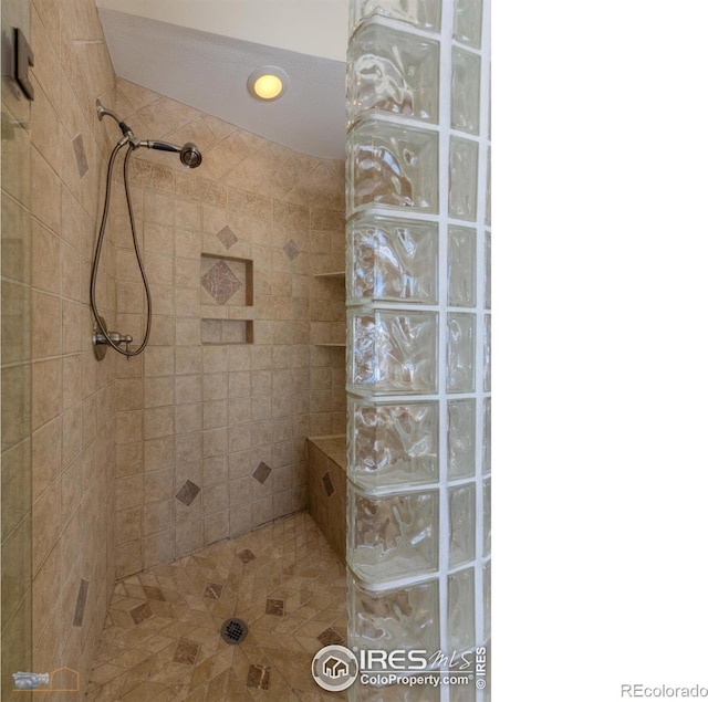 bathroom with a tile shower