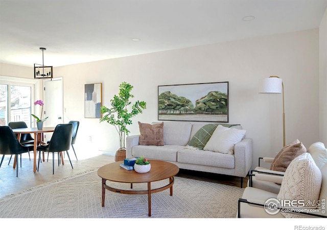 living room featuring an inviting chandelier and light hardwood / wood-style floors