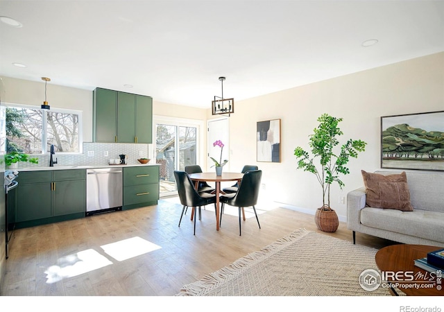 dining space featuring sink and light wood-type flooring