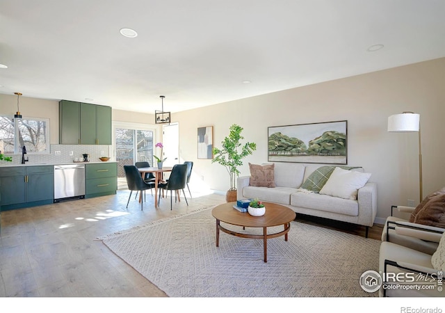 living room with sink and light hardwood / wood-style flooring