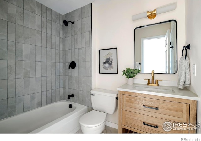 full bathroom featuring vanity, toilet, and tiled shower / bath combo