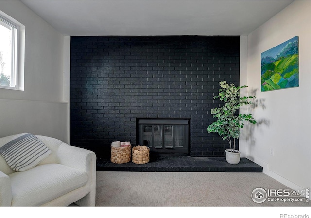 living room featuring a brick fireplace