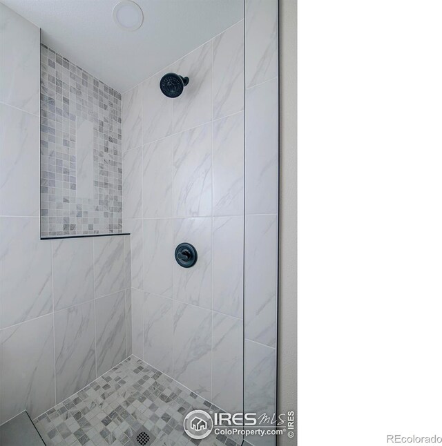 bathroom with a tile shower