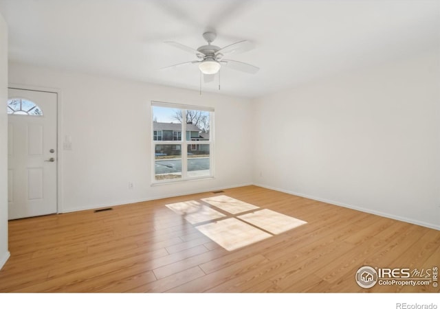 unfurnished room with ceiling fan and light wood-type flooring