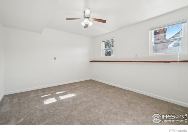 carpeted spare room with ceiling fan