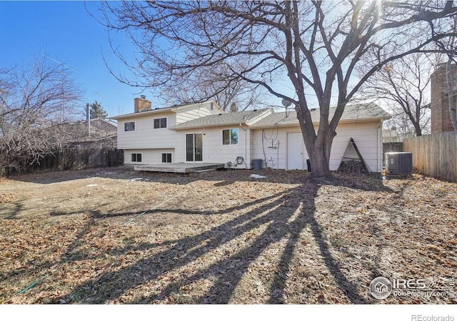 rear view of house featuring cooling unit