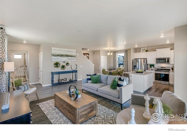 living room featuring dark hardwood / wood-style flooring and a notable chandelier