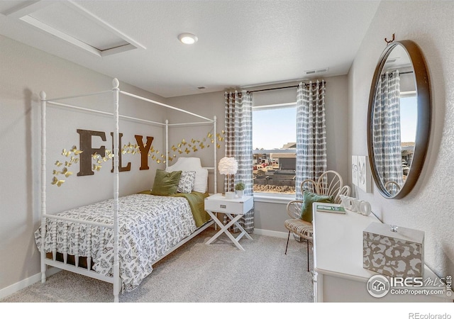 carpeted bedroom with a textured ceiling