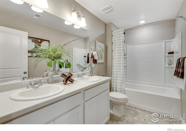 full bathroom featuring vanity, shower / bathtub combination with curtain, and toilet