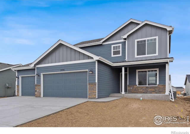 7172 Feather Reed Dr, Wellington, CO 80549 - craftsman-style house featuring stone siding, board and batten siding, covered porch, and an attached garage