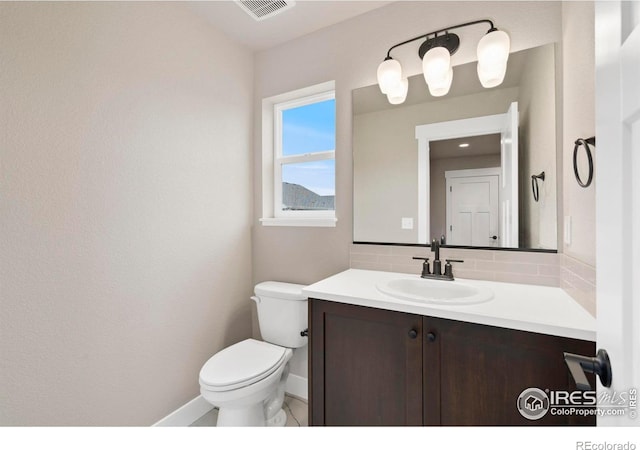 7172 Feather Reed Dr, Wellington, CO 80549 - half bath with visible vents, baseboards, toilet, vanity, and backsplash