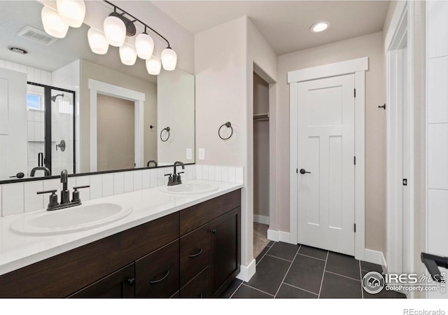 7172 Feather Reed Dr, Wellington, CO 80549 - full bathroom featuring visible vents, a sink, a stall shower, and tile patterned flooring