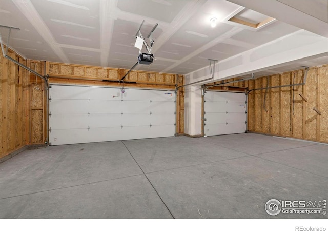 7172 Feather Reed Dr, Wellington, CO 80549 - garage with wood walls and a garage door opener