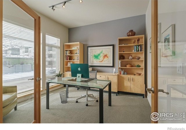 carpeted home office featuring french doors and rail lighting