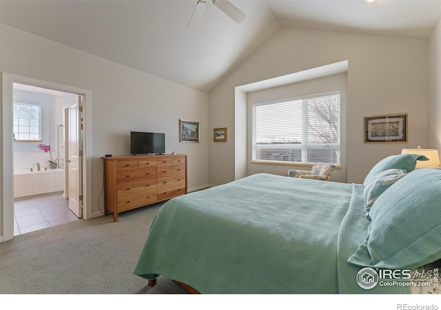 bedroom with multiple windows, vaulted ceiling, connected bathroom, and light colored carpet