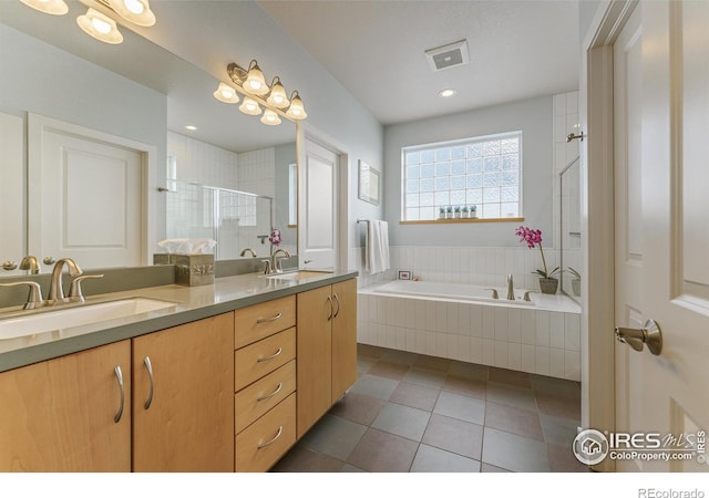 bathroom featuring vanity, plus walk in shower, and tile patterned flooring