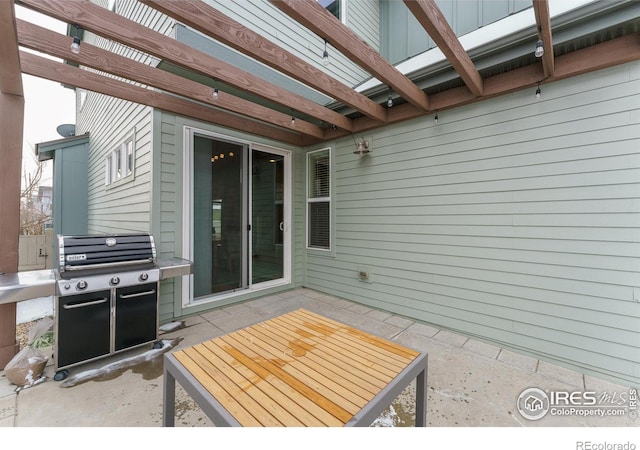 view of patio featuring area for grilling and a pergola