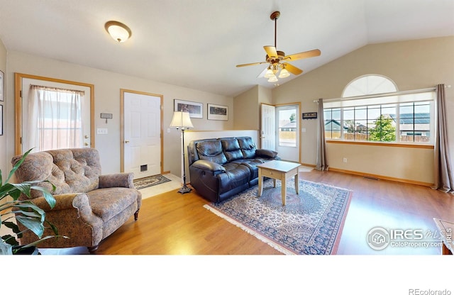 living room with hardwood / wood-style flooring, lofted ceiling, and ceiling fan