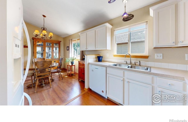 kitchen with white cabinetry, dishwasher, sink, and hanging light fixtures