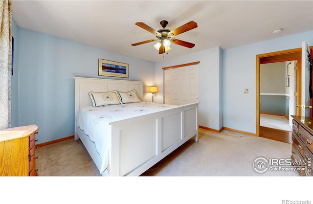 carpeted bedroom featuring ceiling fan and a closet